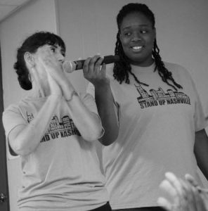 Odessa Kelly holding microphone to fellow Nashvillian at Stand Up Nashville community meeting
