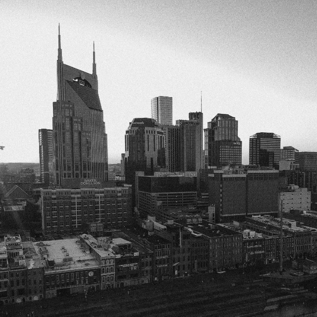 Black and white grainy image of Nashville's skyline showing iconic skyscrapers and blocks of apartment buildings downtown